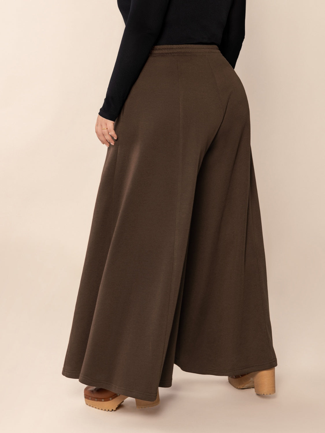 Plus size wide leg pants with pockets and ruched detail, opaque.
