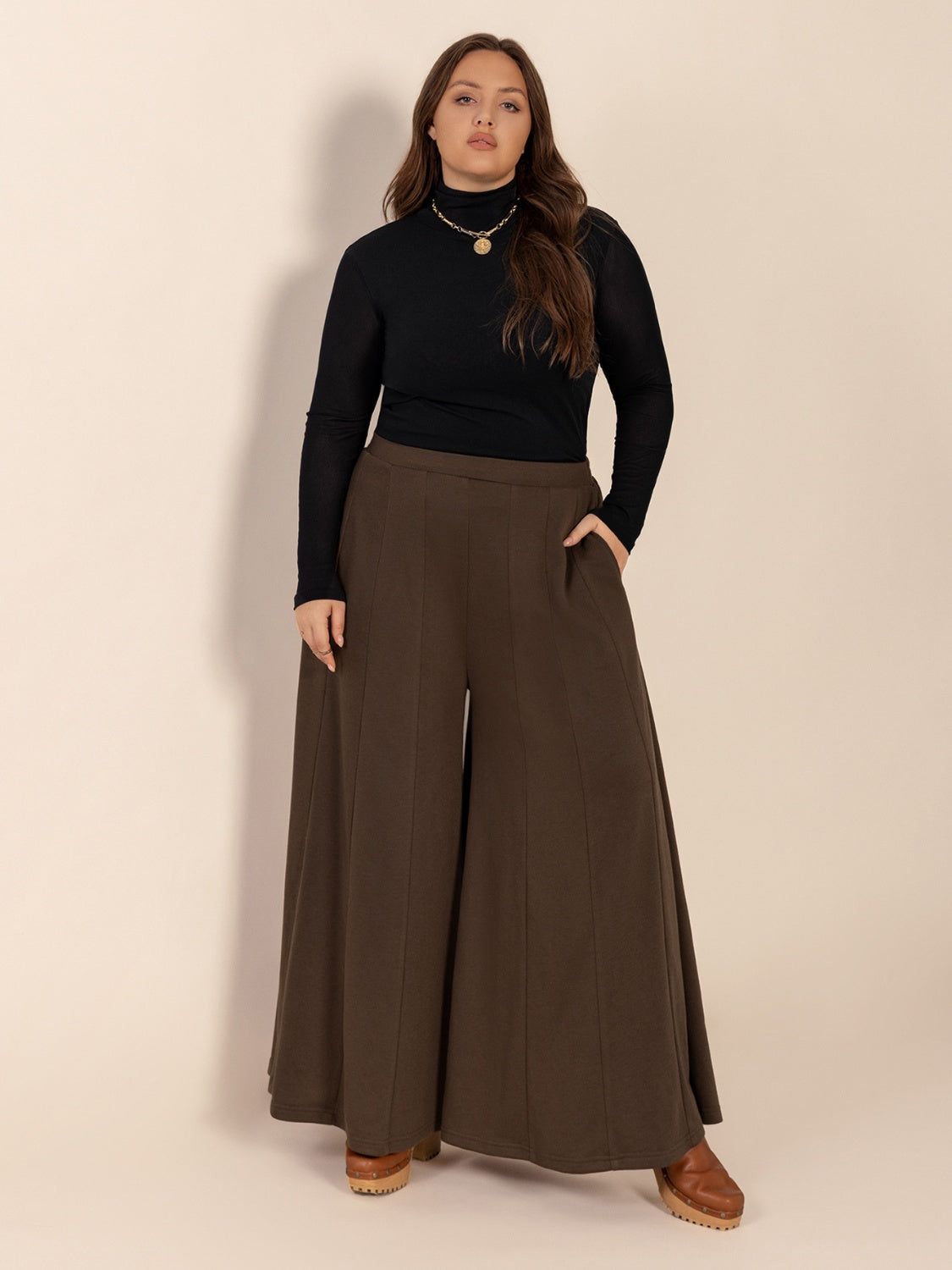 Plus size wide leg pants with pockets and ruched detail, opaque.