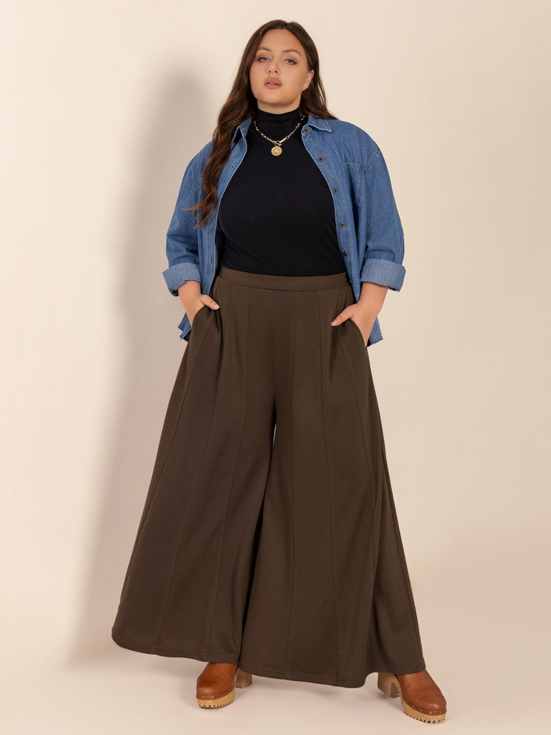 Plus size wide leg pants with pockets and ruched detail, opaque.