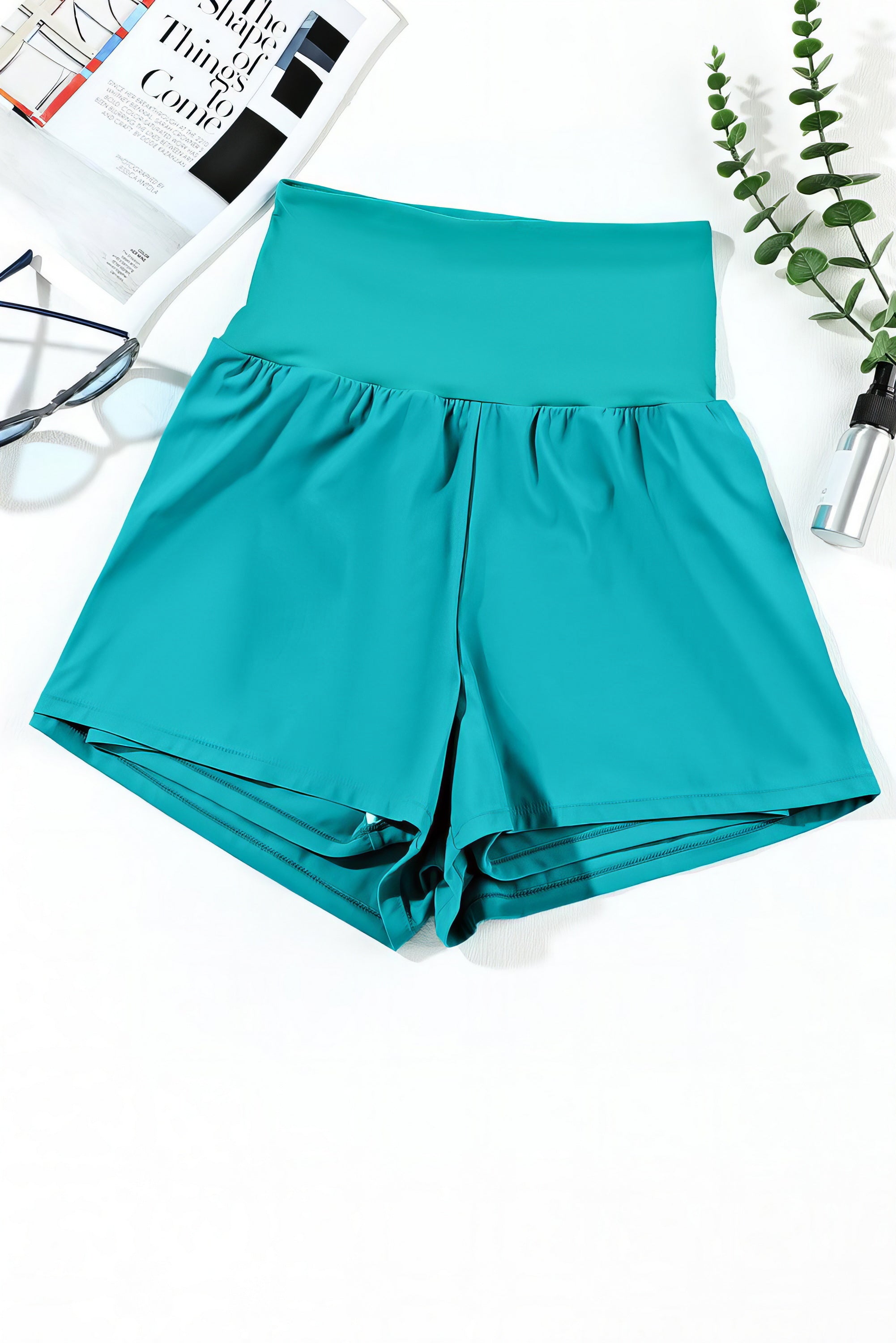 Turquoise High Waist Swim Shorts with Pockets. Stretchy, secure fit. Perfect for swimming, running, or relaxing. Phone fits in pocket.
