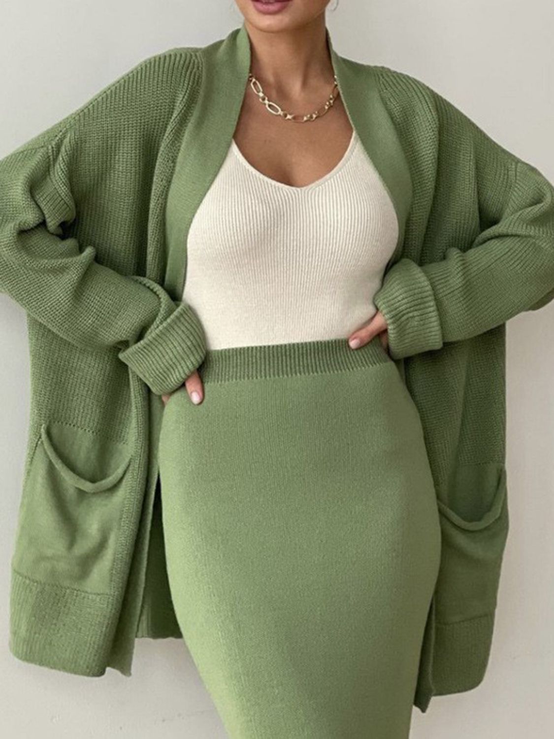 Two-piece set: pocketed long sleeve cardigan and matching skirt sweater set.