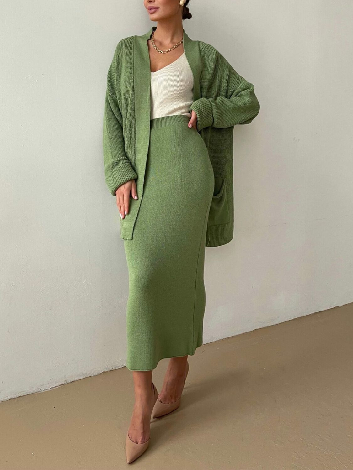 Two-piece set: pocketed long sleeve cardigan and matching skirt sweater set.