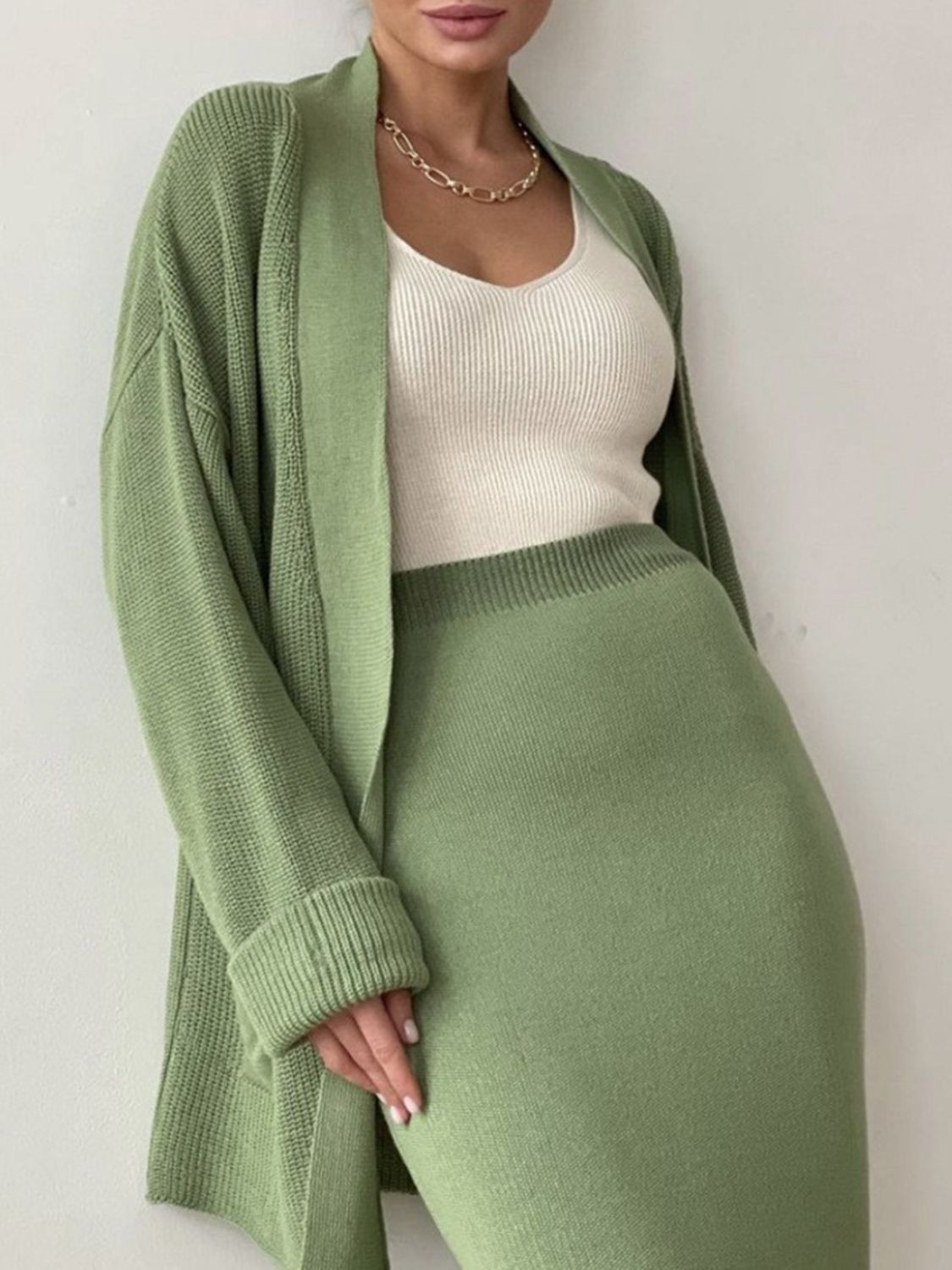 Two-piece set: pocketed long sleeve cardigan and matching skirt sweater set.
