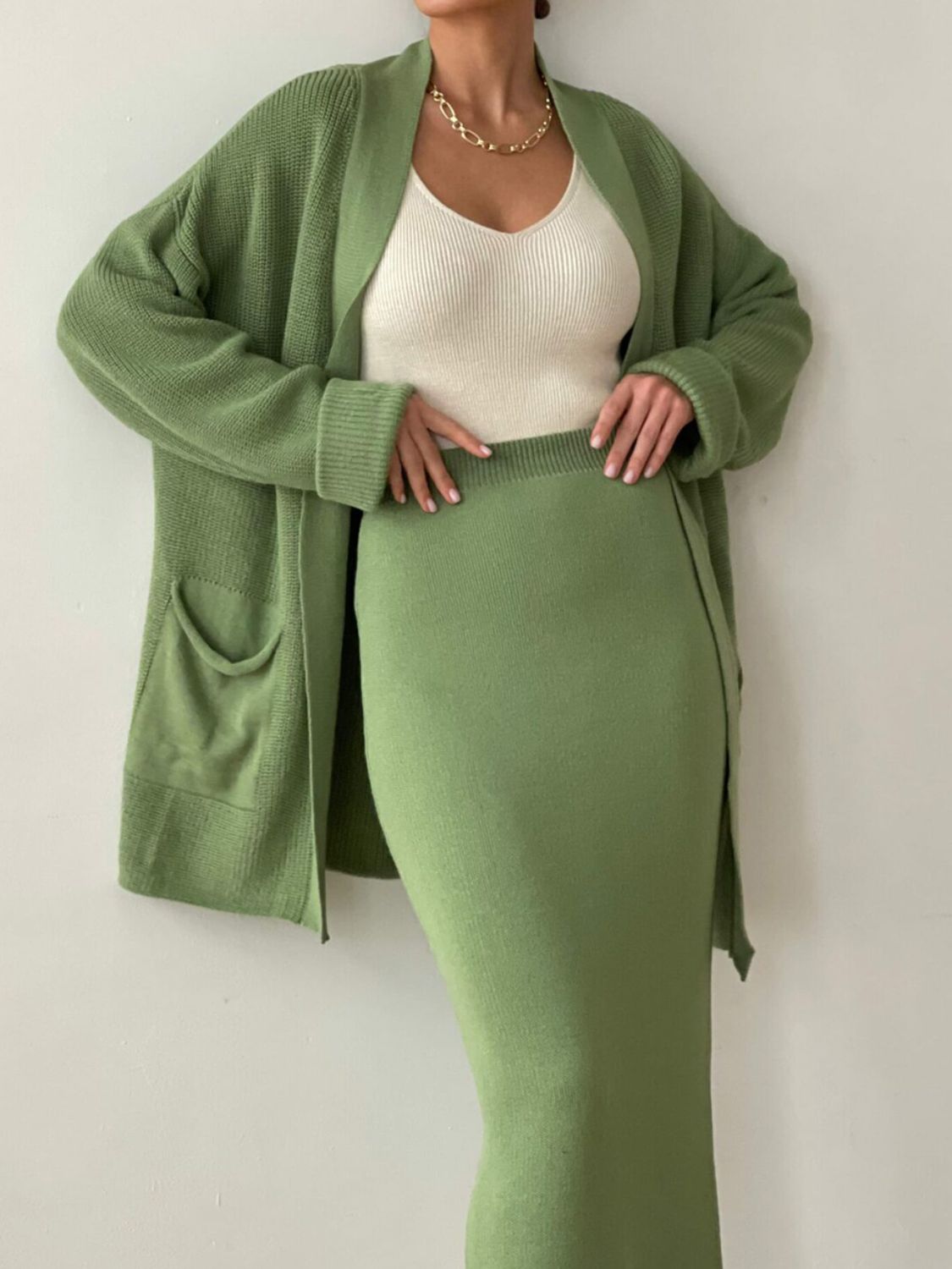 Two-piece set: pocketed long sleeve cardigan and matching skirt sweater set.