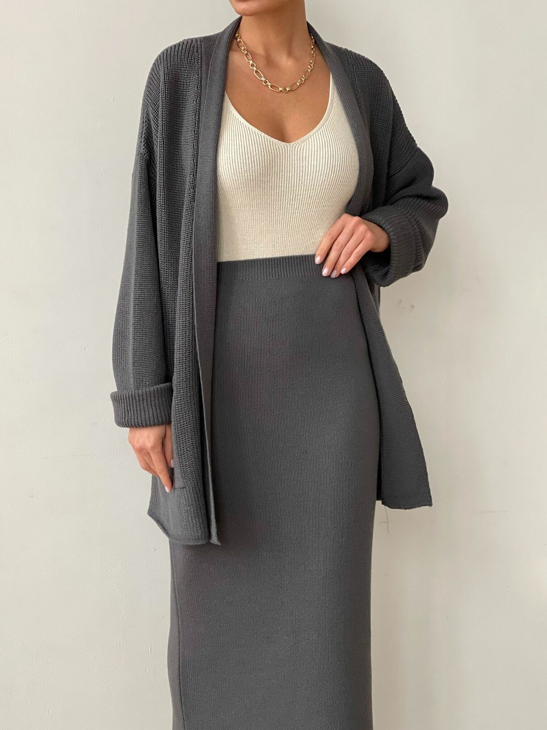 Two-piece set: pocketed long sleeve cardigan and matching skirt sweater set.