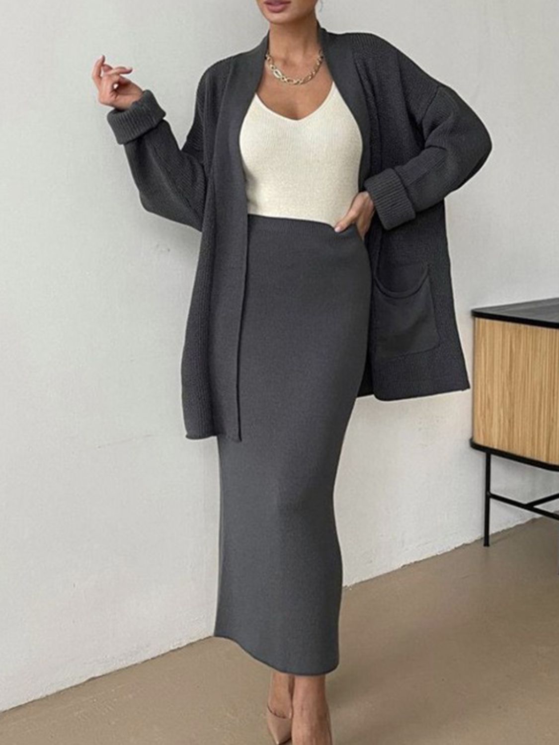 Two-piece set: pocketed long sleeve cardigan and matching skirt sweater set.