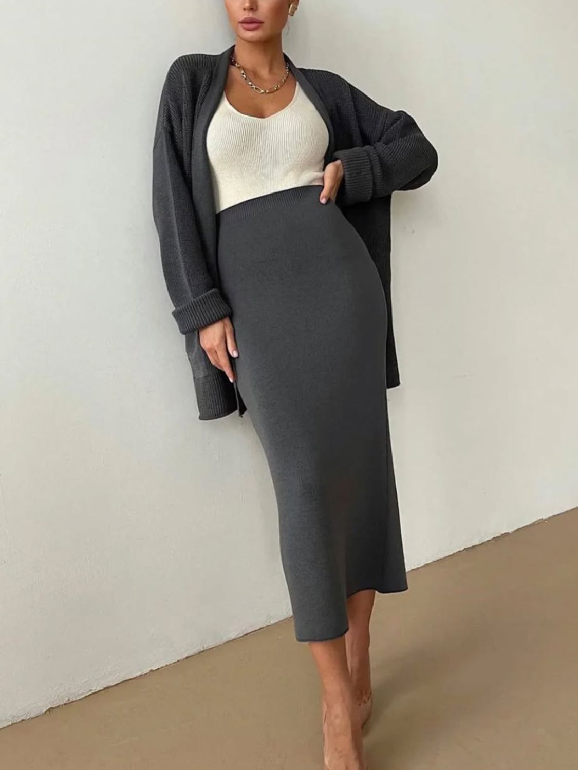 Two-piece set: pocketed long sleeve cardigan and matching skirt sweater set.