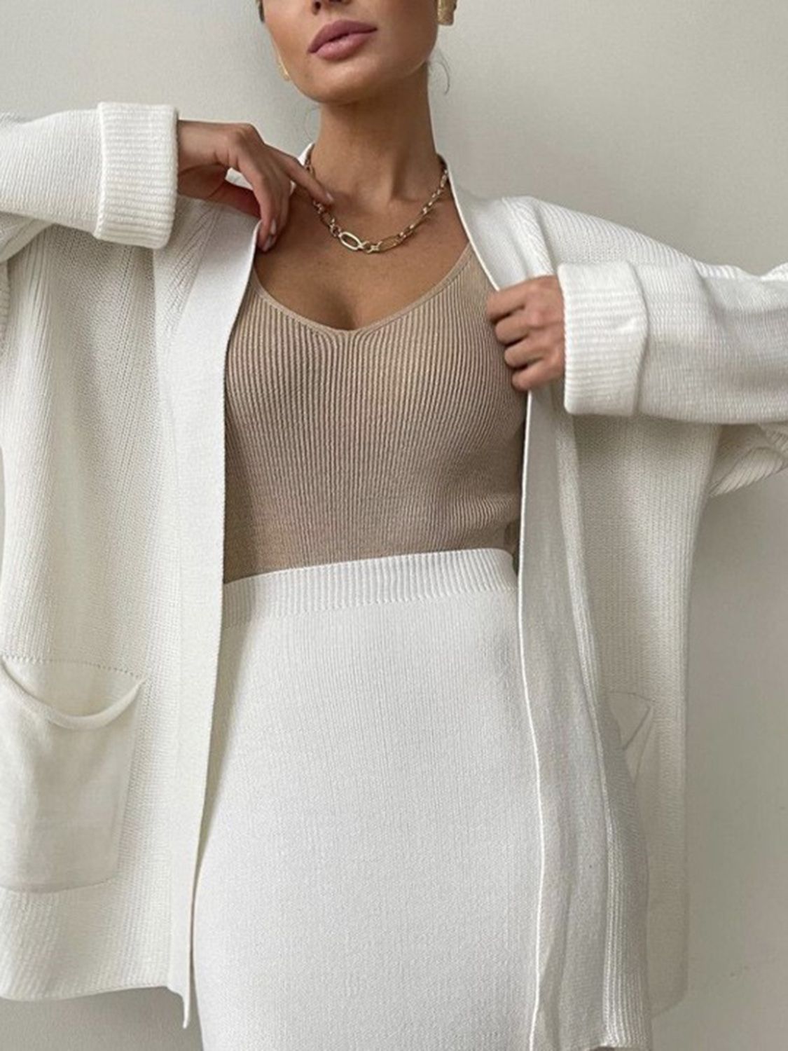 Two-piece set: pocketed long sleeve cardigan and matching skirt sweater set.