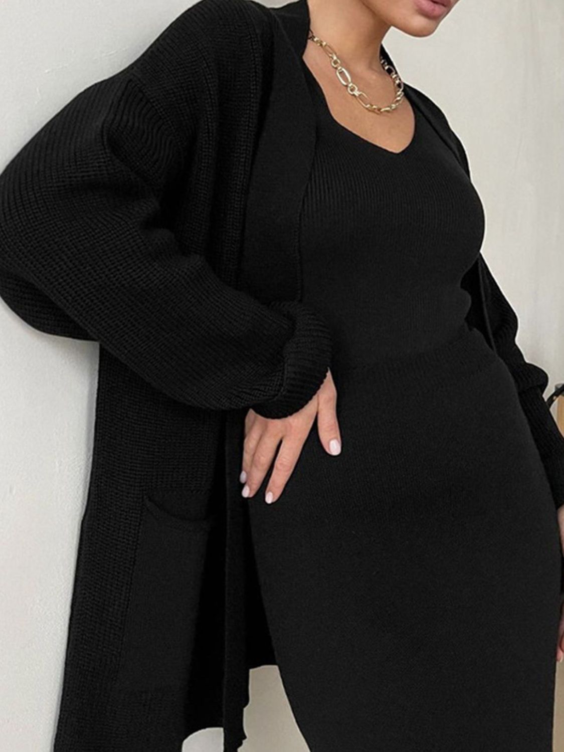 Two-piece set: pocketed long sleeve cardigan and matching skirt sweater set.