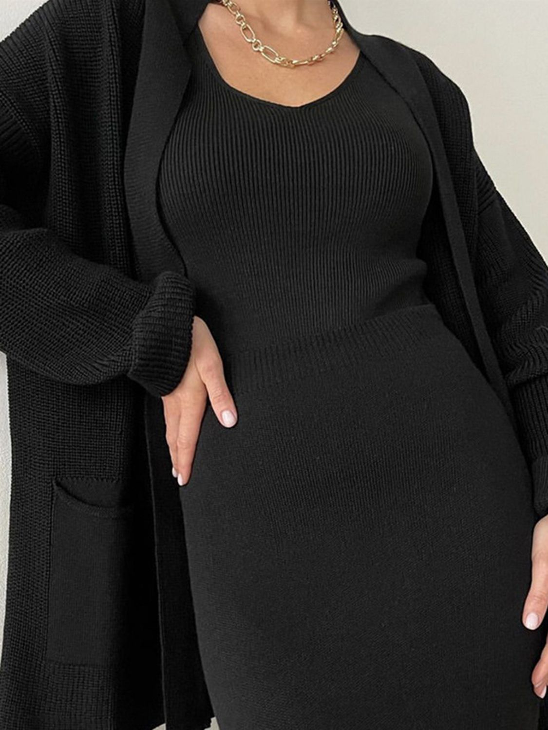 Two-piece set: pocketed long sleeve cardigan and matching skirt sweater set.