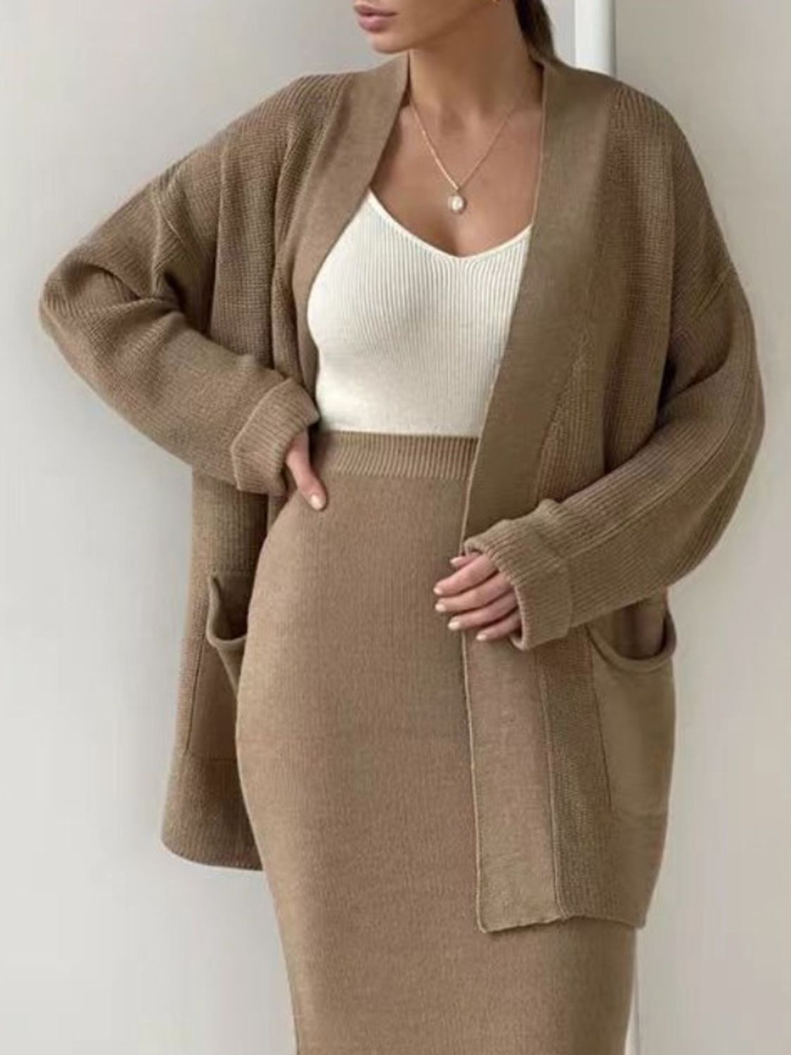 Two-piece set: pocketed long sleeve cardigan and matching skirt sweater set.