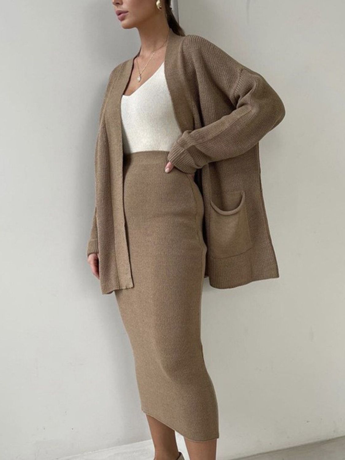 Two-piece set: pocketed long sleeve cardigan and matching skirt sweater set.