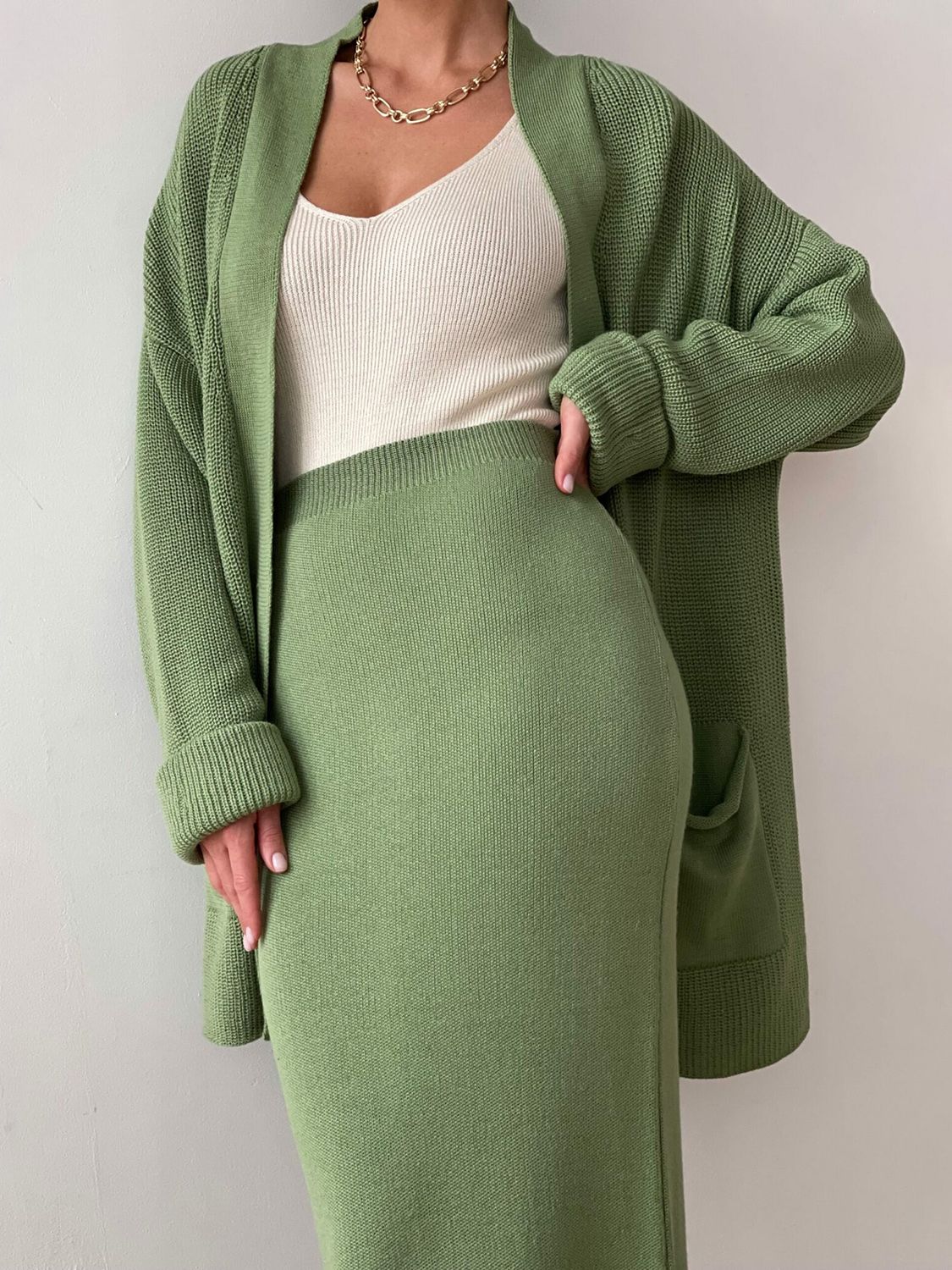 Two-piece set: pocketed long sleeve cardigan and matching skirt sweater set.