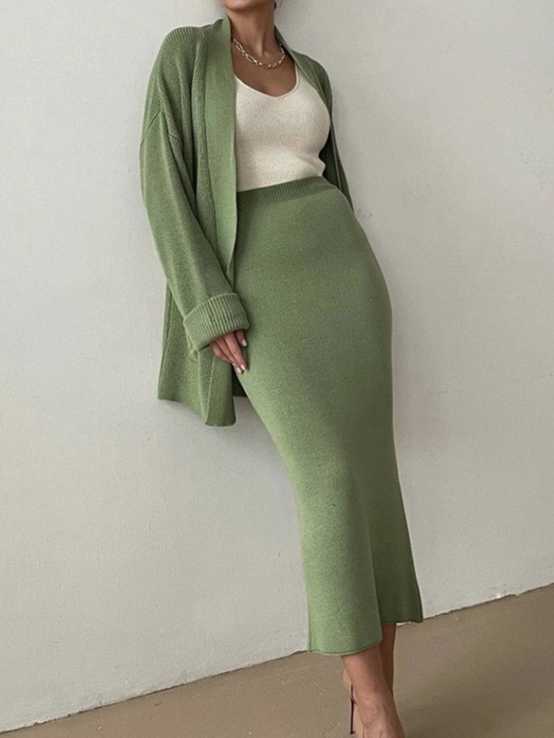 Two-piece set: pocketed long sleeve cardigan and matching skirt sweater set.