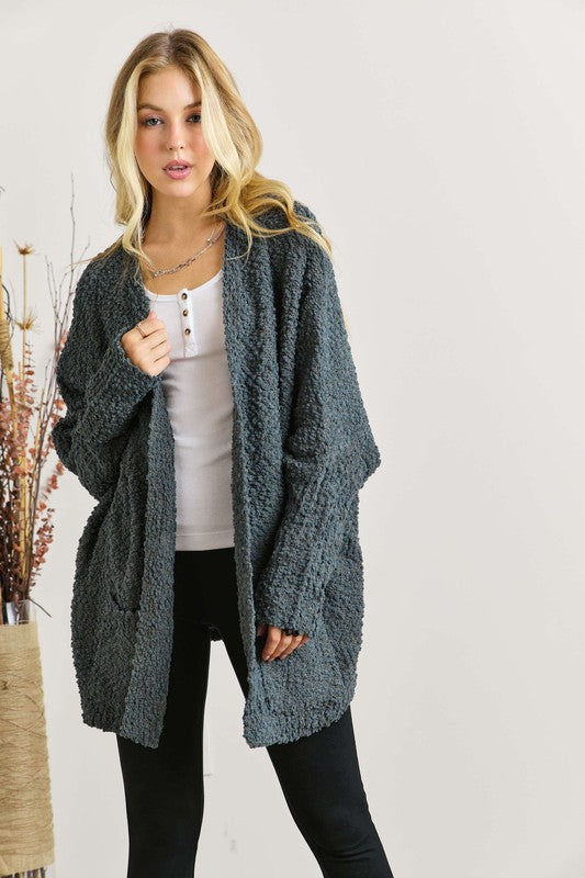 Popcorn knit open front long sleeve cardigan with ribbed pockets.