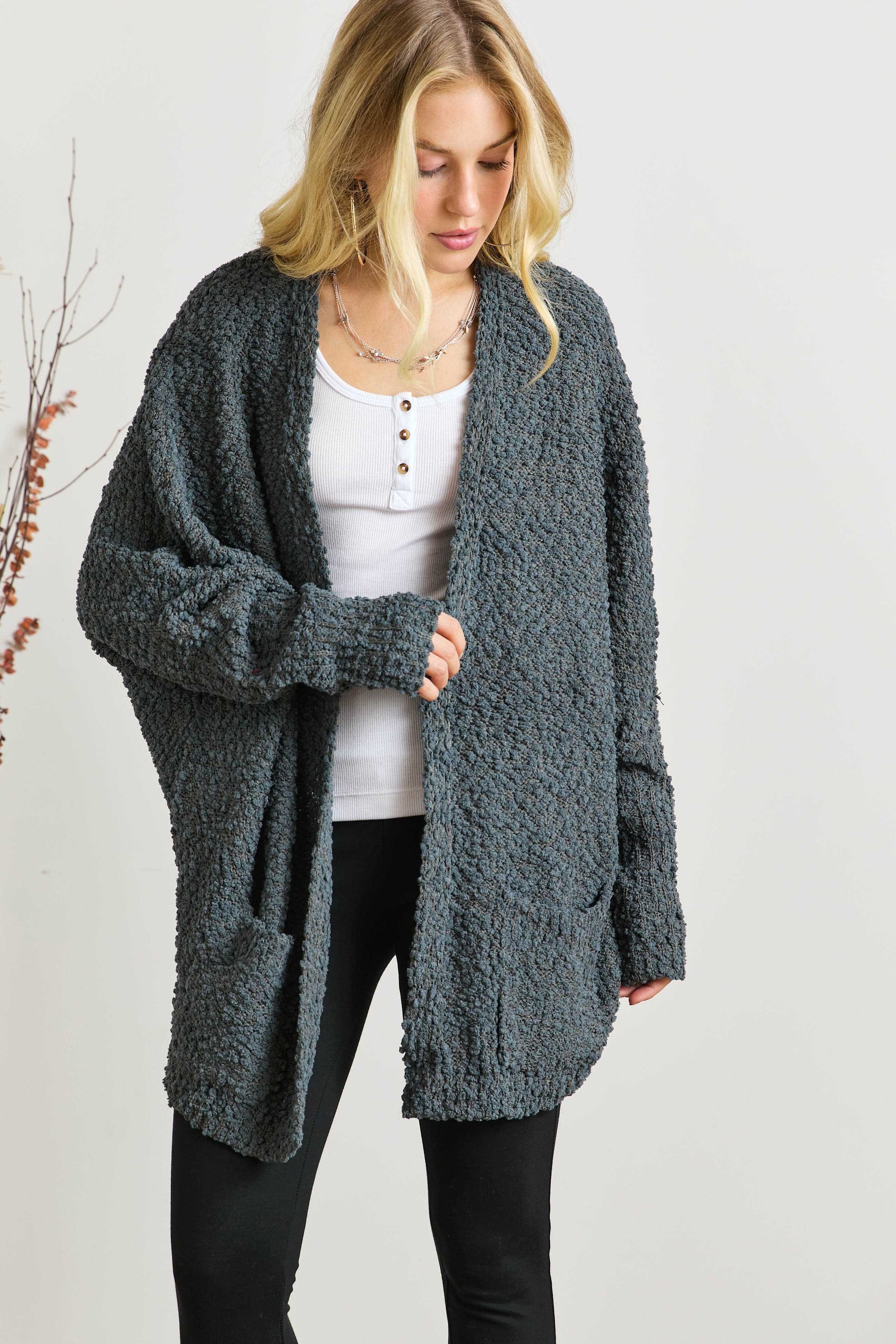 Popcorn knit open front long sleeve cardigan with ribbed pockets.