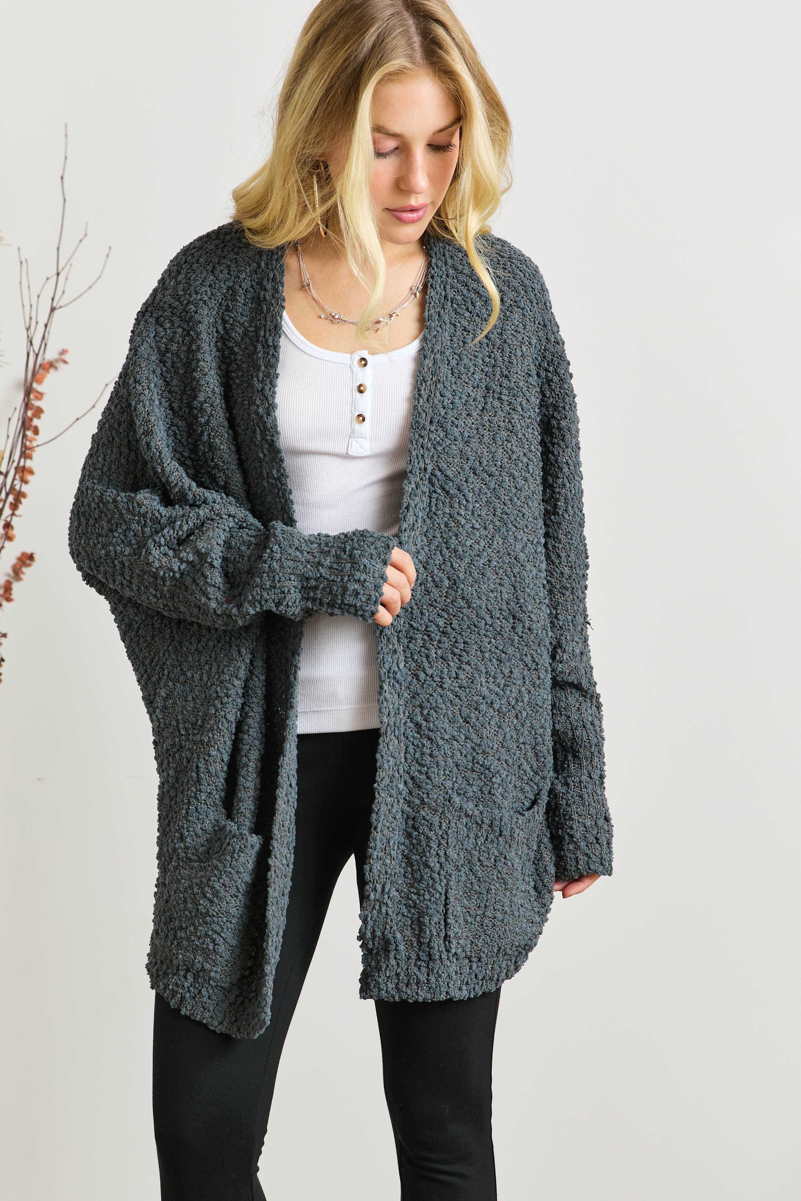 Popcorn knit open front long sleeve cardigan with ribbed pockets.