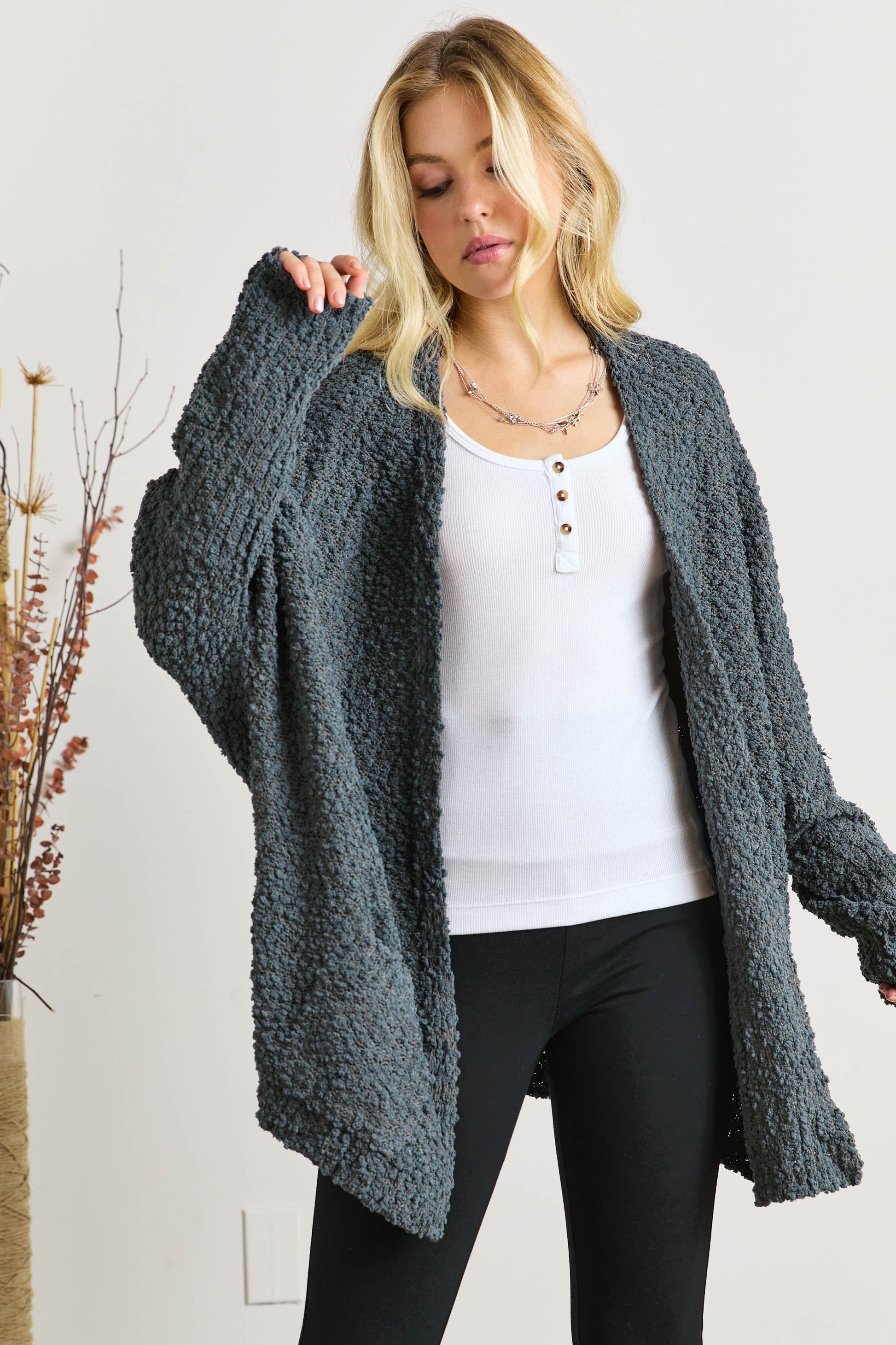 Popcorn knit open front long sleeve cardigan with ribbed pockets.