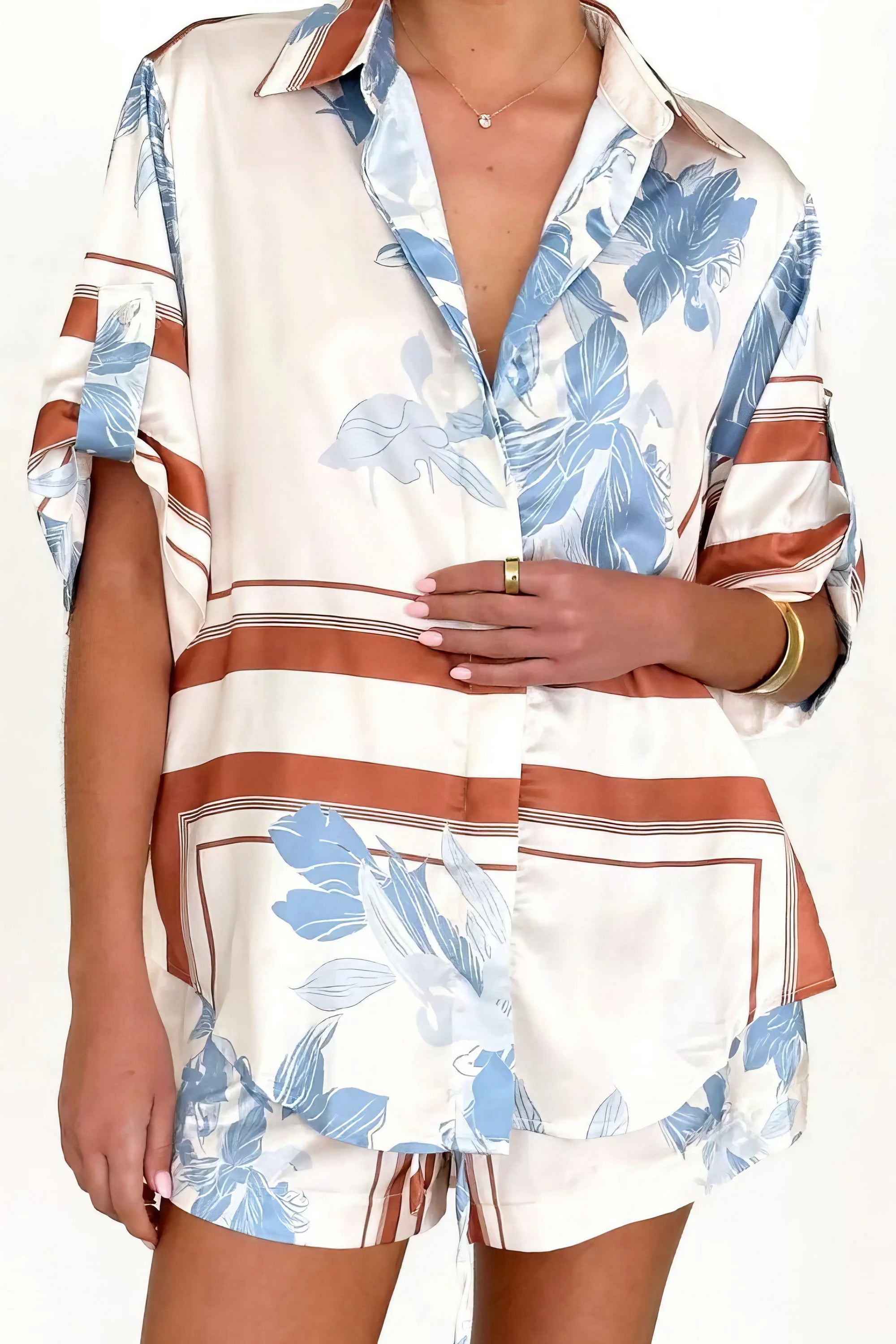 printed collared neck top and shorts set, polished women's two-piece outfit, classic style summer fashion, comfortable printed set, buttoned top, tailored shorts, sophisticated casual wear