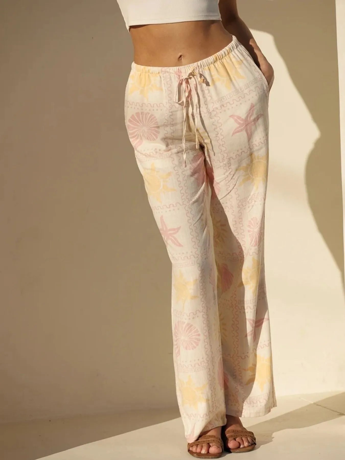Printed drawstring straight pants with pockets.