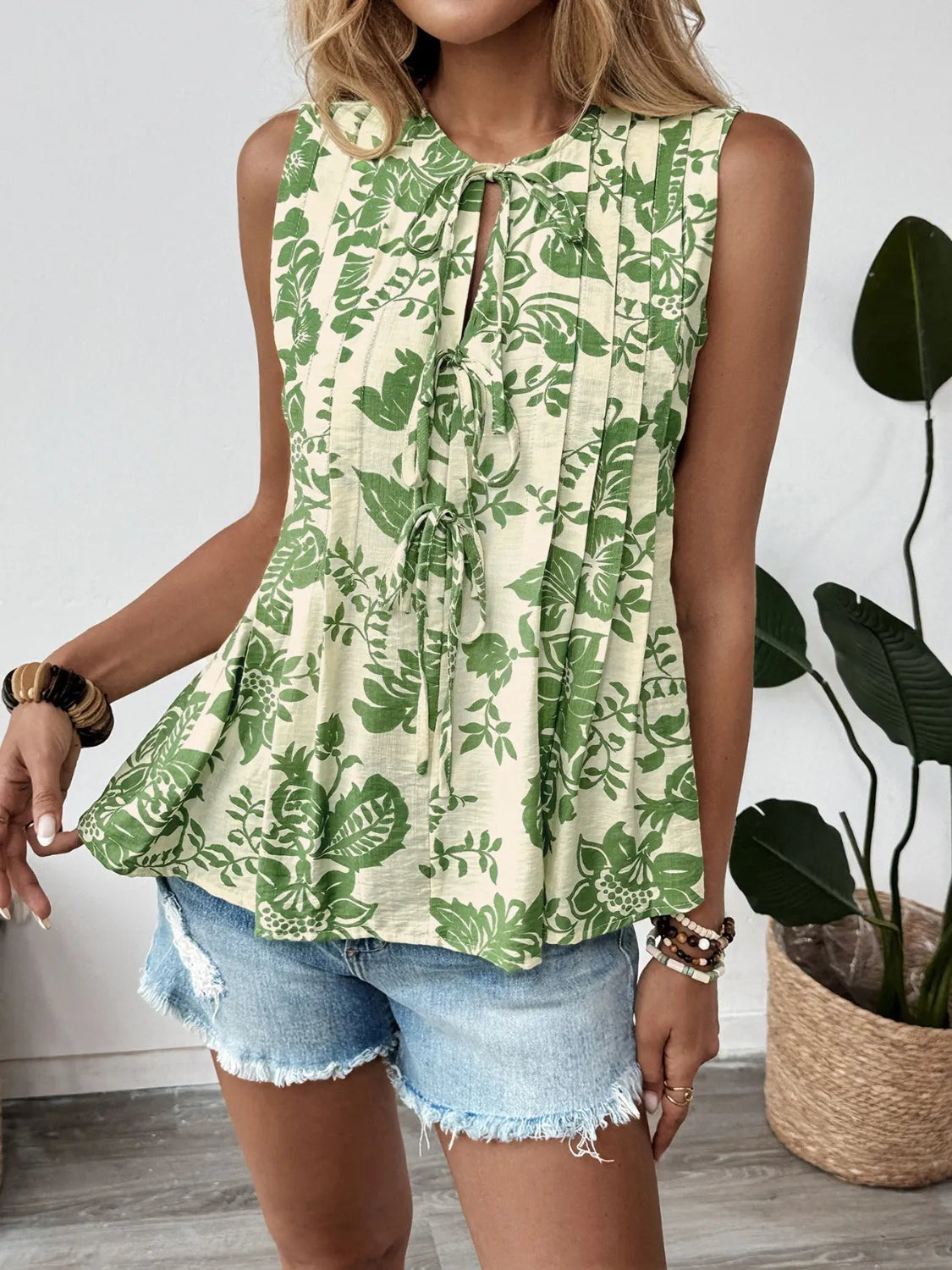 Printed Sleeveless Ruffle Peplum Blouse.