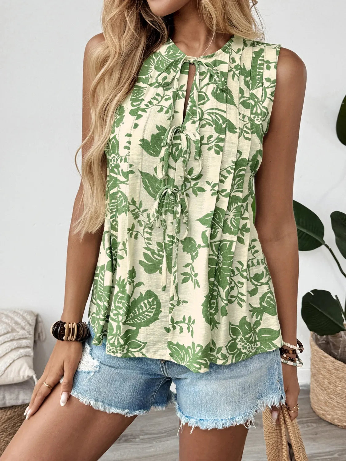 Printed Sleeveless Ruffle Peplum Blouse.