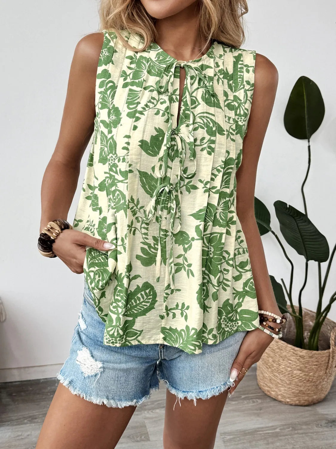 Printed Sleeveless Ruffle Peplum Blouse.