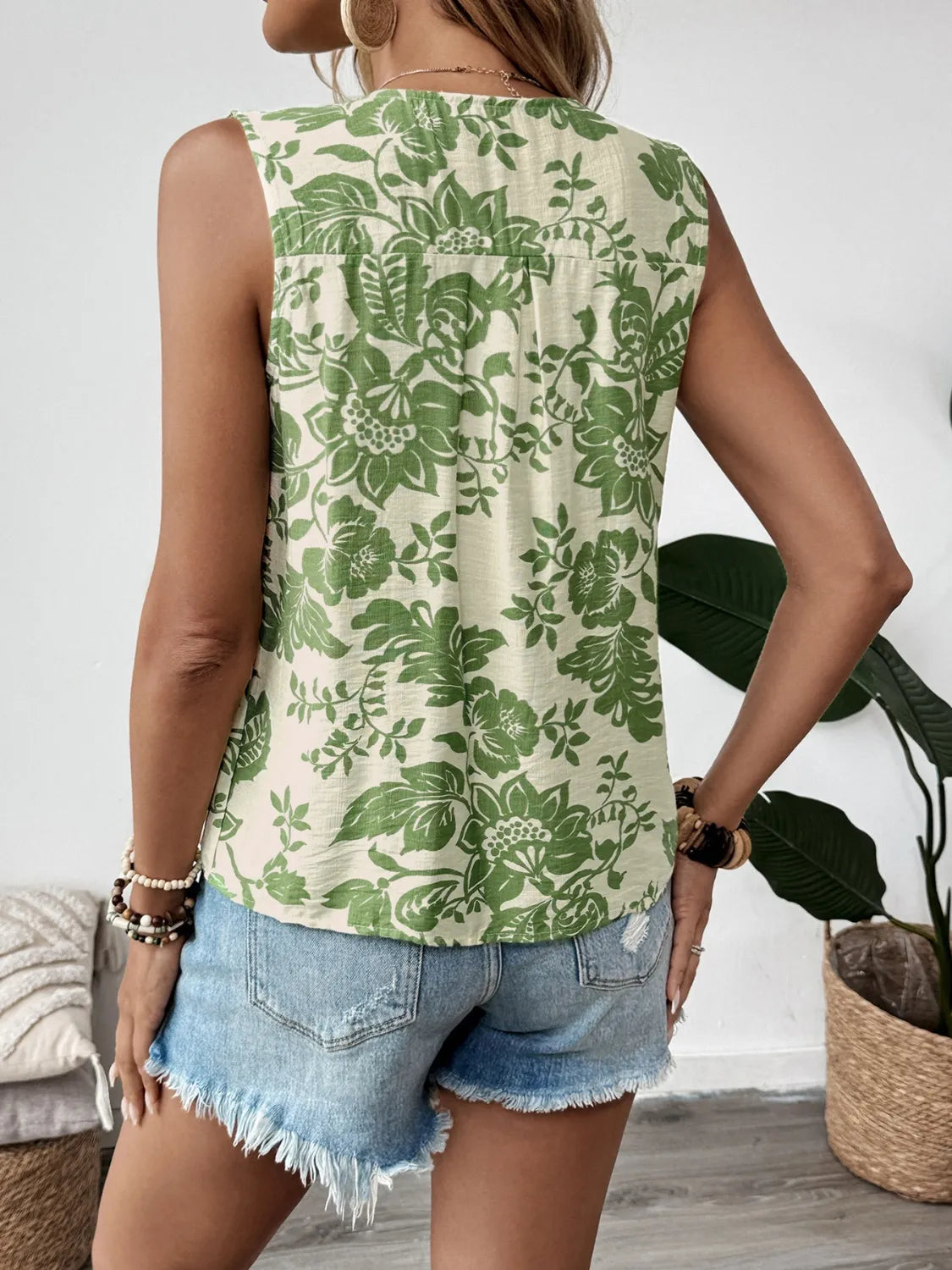 Printed Sleeveless Ruffle Peplum Blouse.