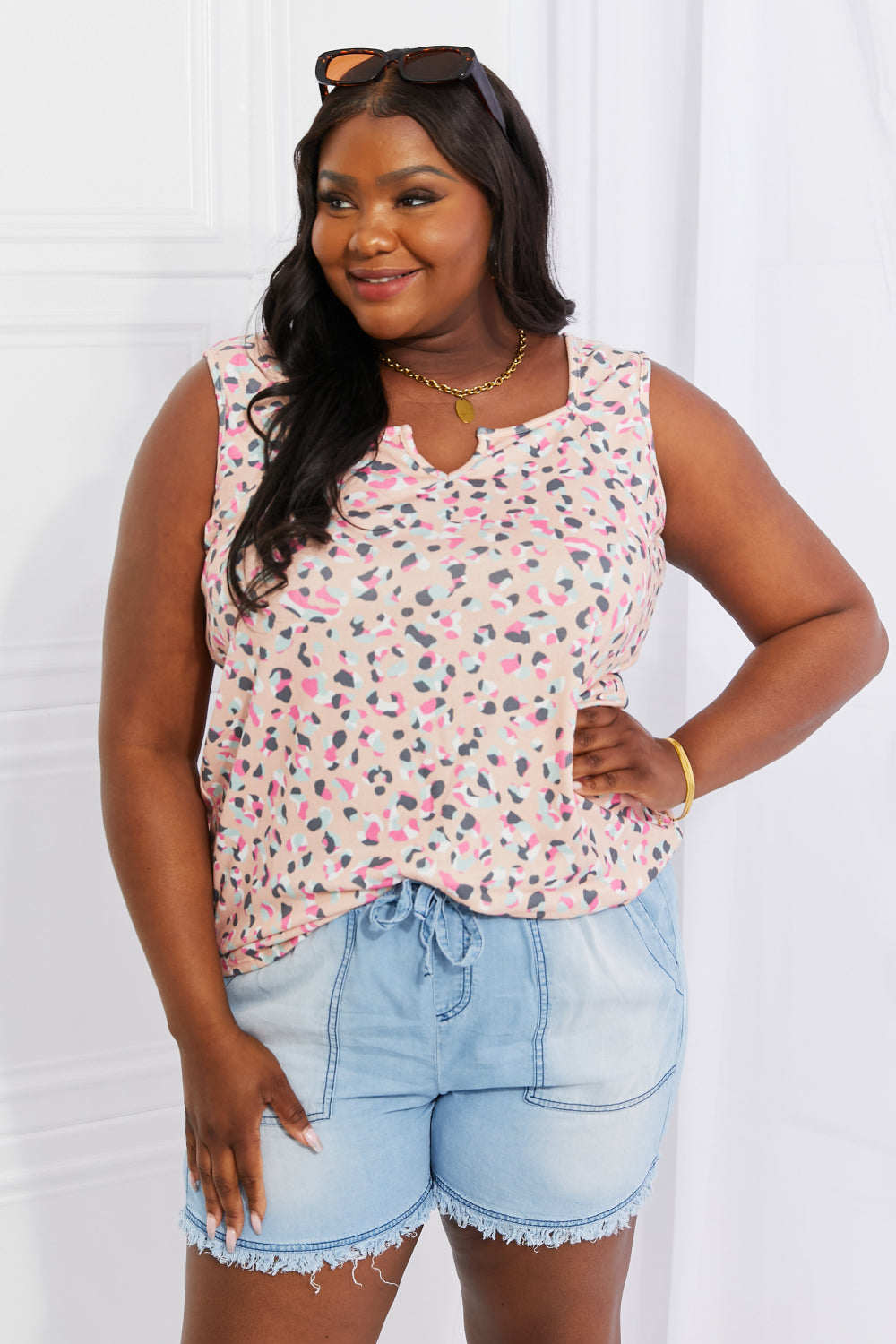Full size printed sleeveless top with notched neckline, highly stretchy.