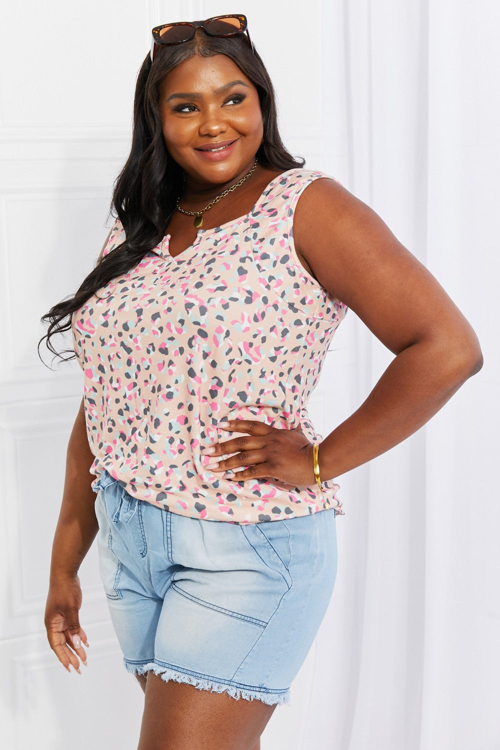 Full size printed sleeveless top with notched neckline, highly stretchy.