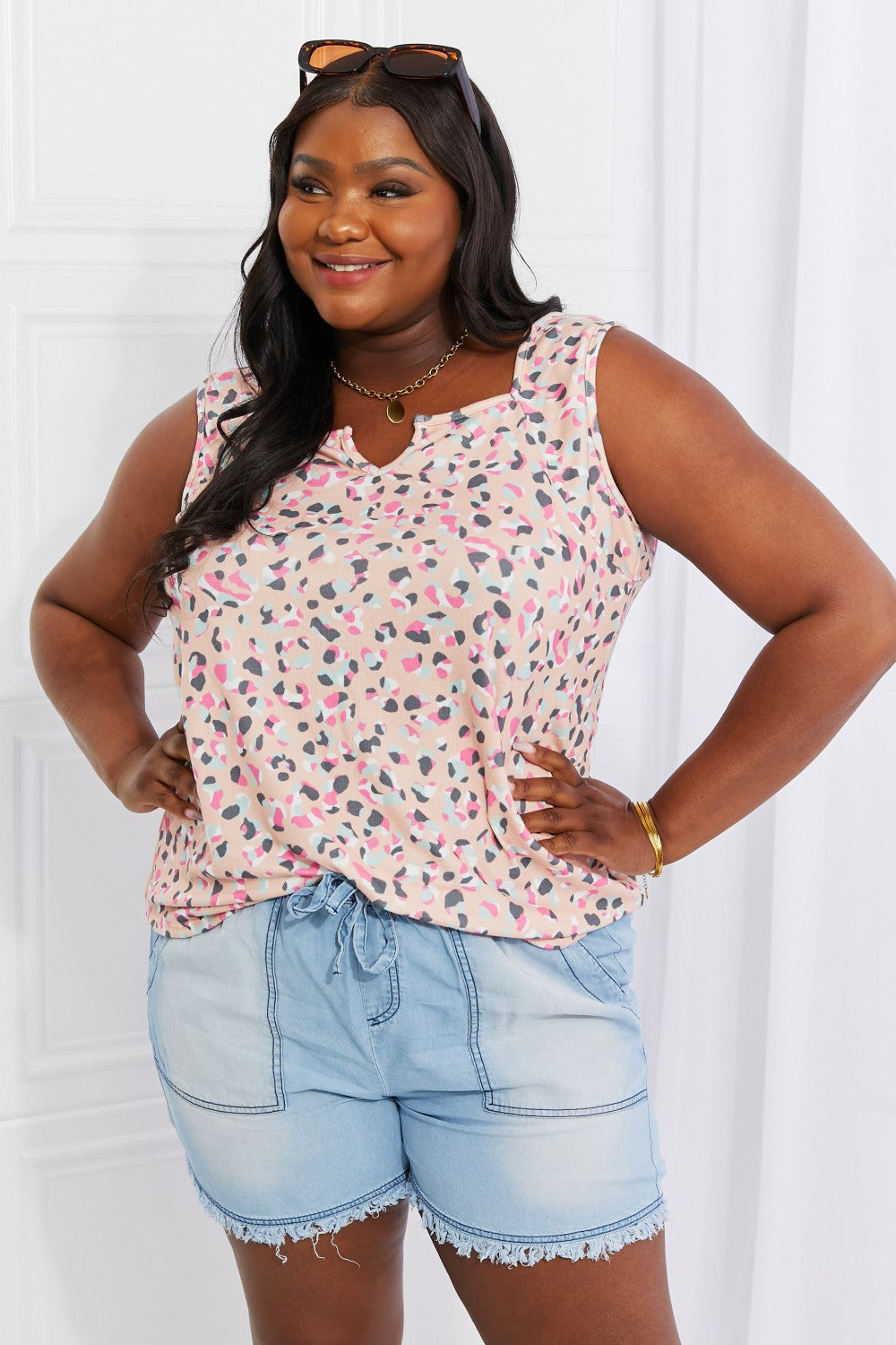 Full size printed sleeveless top with notched neckline, highly stretchy.