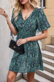 Perfee Printed Smocked Crisscross V-Neck Mini Dress.