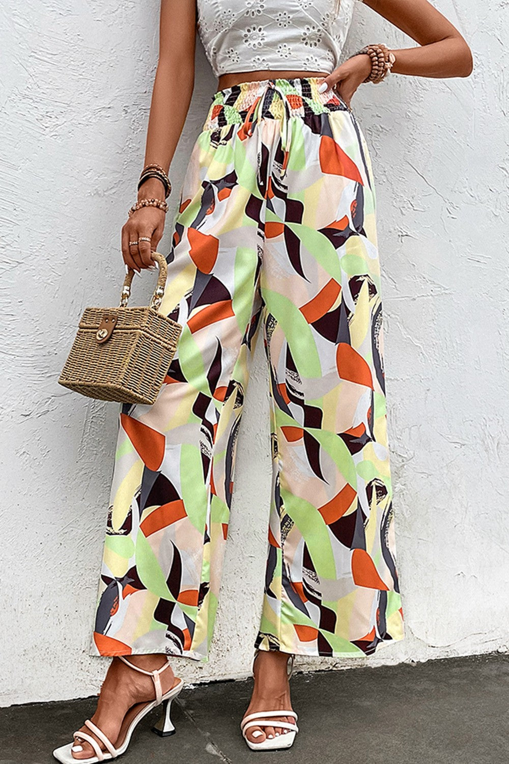 Shiny printed smocked waist wide leg pants, casual chic style.