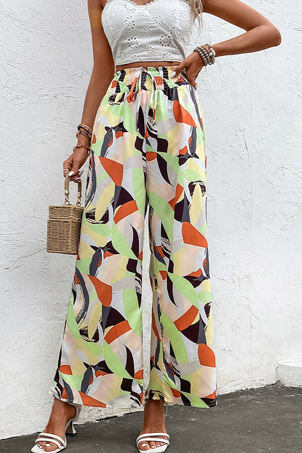 Shiny printed smocked waist wide leg pants, casual chic style.