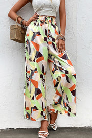 Shiny printed smocked waist wide leg pants, casual chic style.