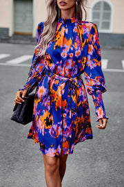 Devine Printed Tie Waist Mock Neck Lantern Sleeve Dress.