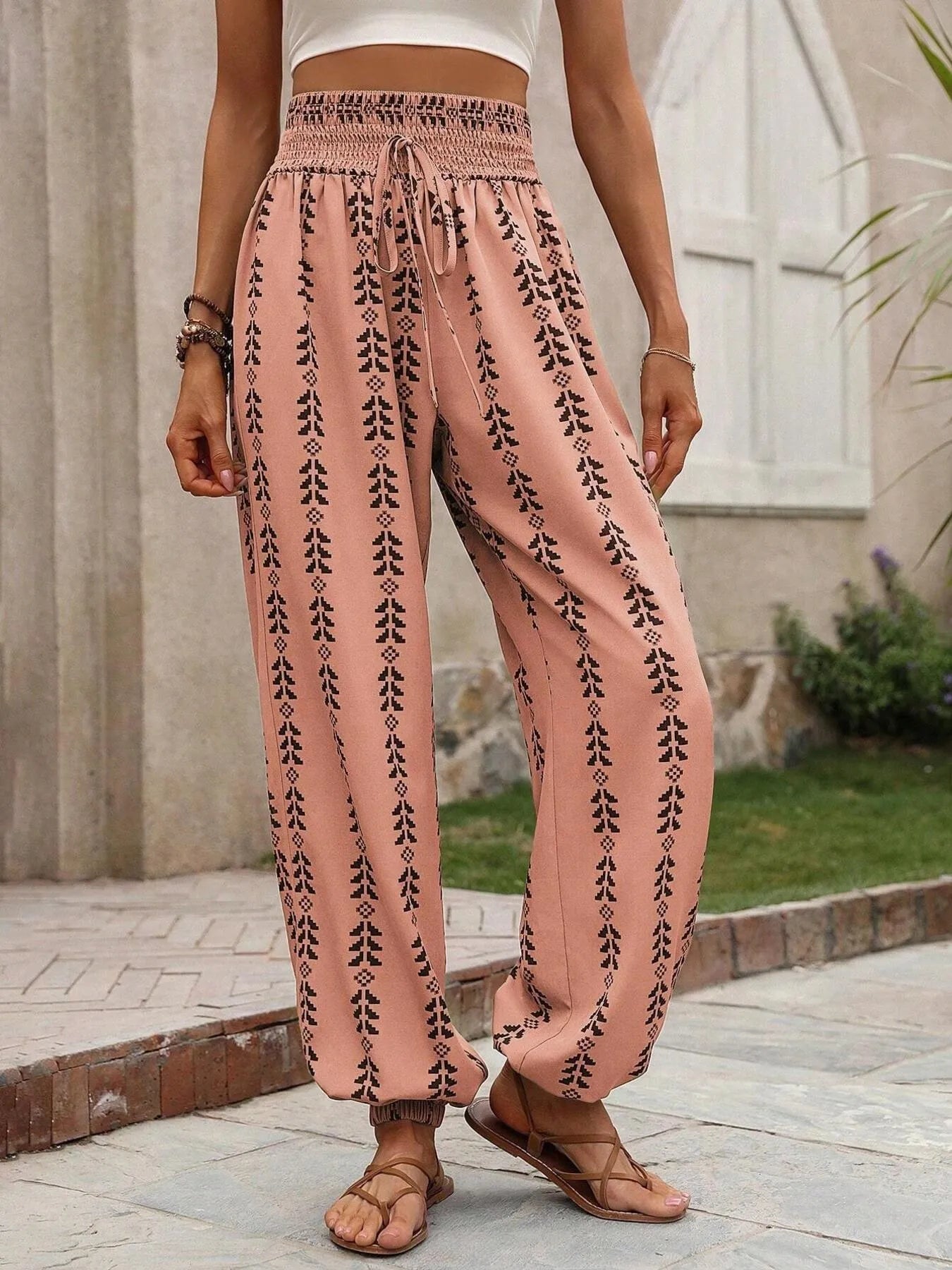 Printed wide leg pants with drawstring, pockets, and smocking.