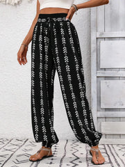 Printed wide leg pants with drawstring, pockets, and smocking.