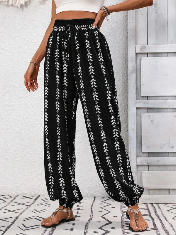 Printed wide leg pants with drawstring, pockets, and smocking.