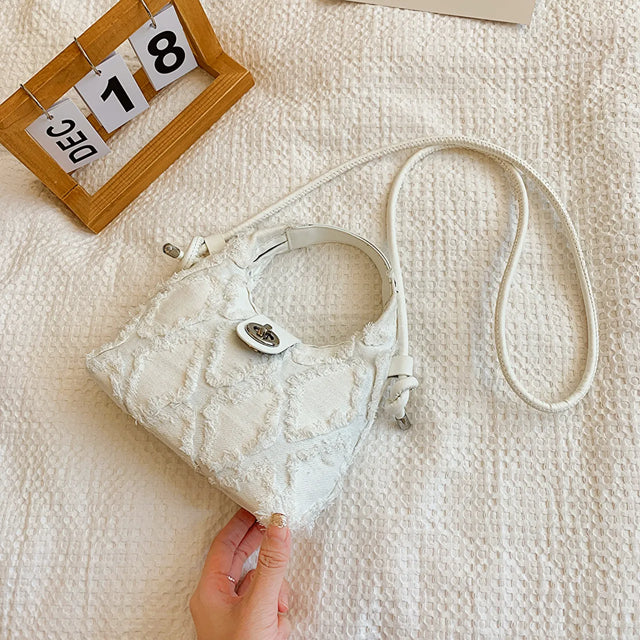 Small quilted raw hem mini crossbody bag.