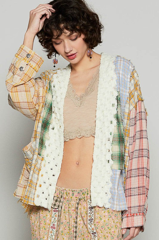 Raw edge plaid open front cardigan with exposed seams.