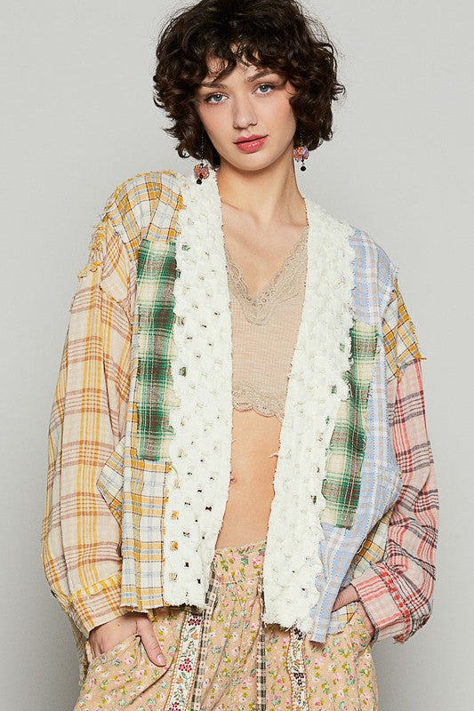 Raw edge plaid open front cardigan with exposed seams.