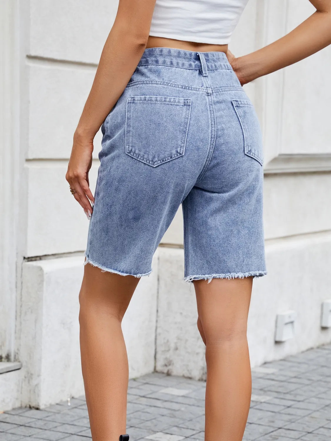 High waist criss-cross waistband denim shorts with pockets.