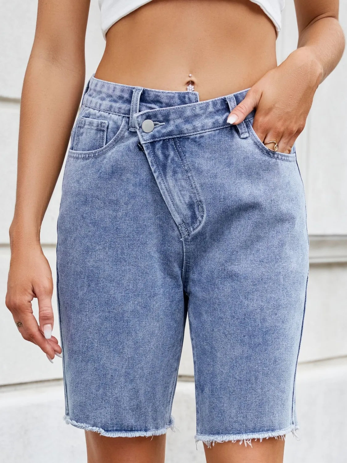 High waist criss-cross waistband denim shorts with pockets.
