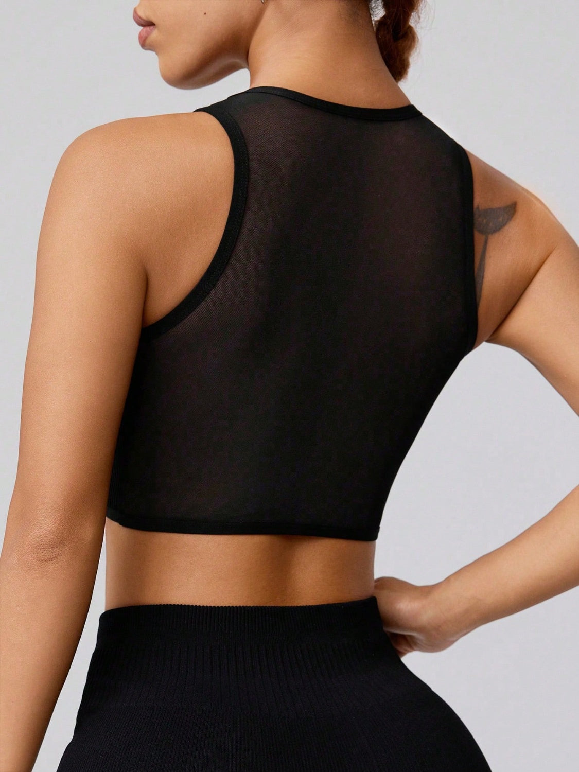 Round neck active tank, opaque and moderately stretchy.