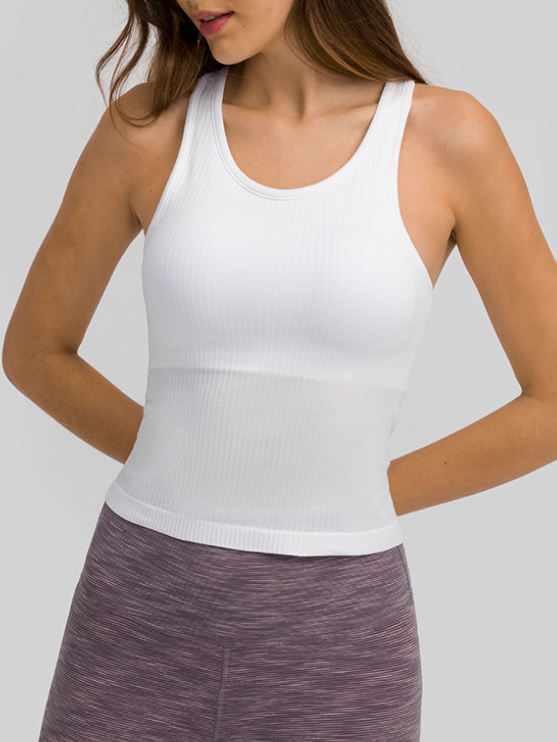 Round neck racerback active tank with removable padding.