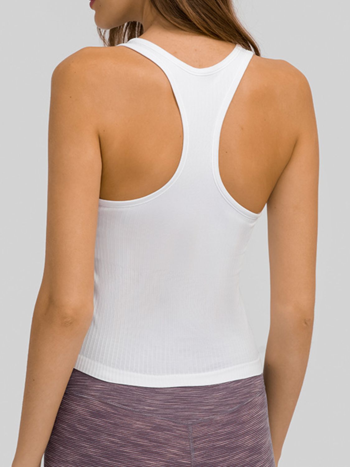 Round neck racerback active tank with removable padding.