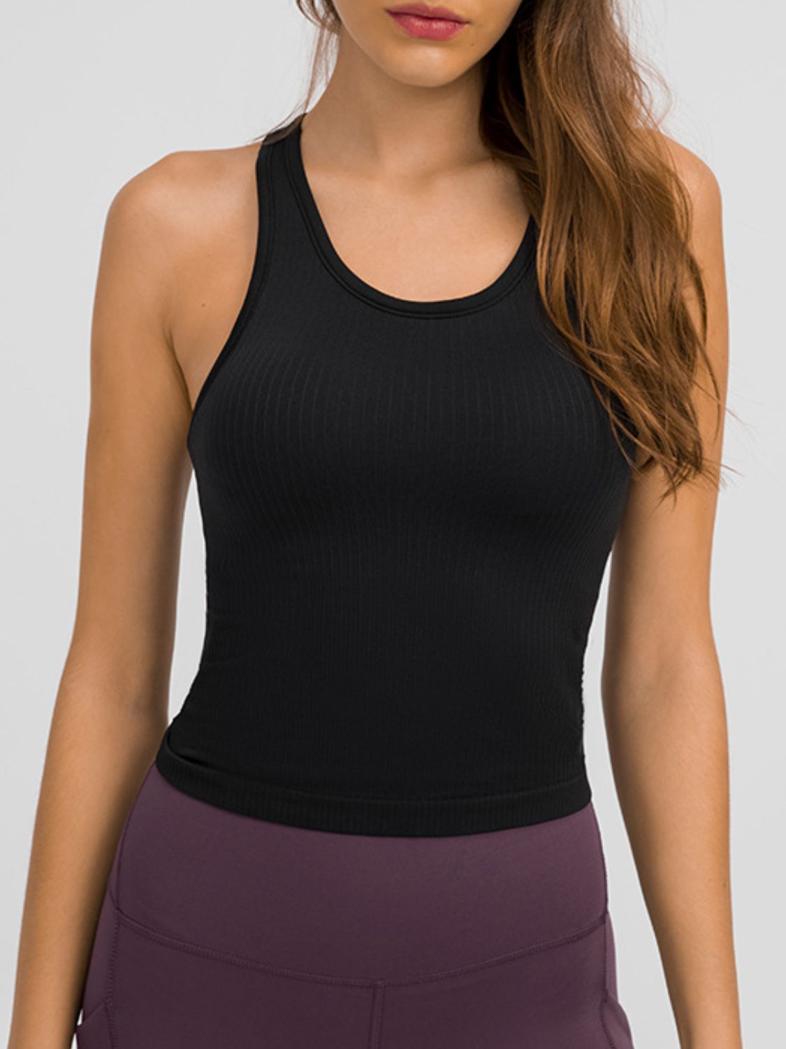 Round neck racerback active tank with removable padding.