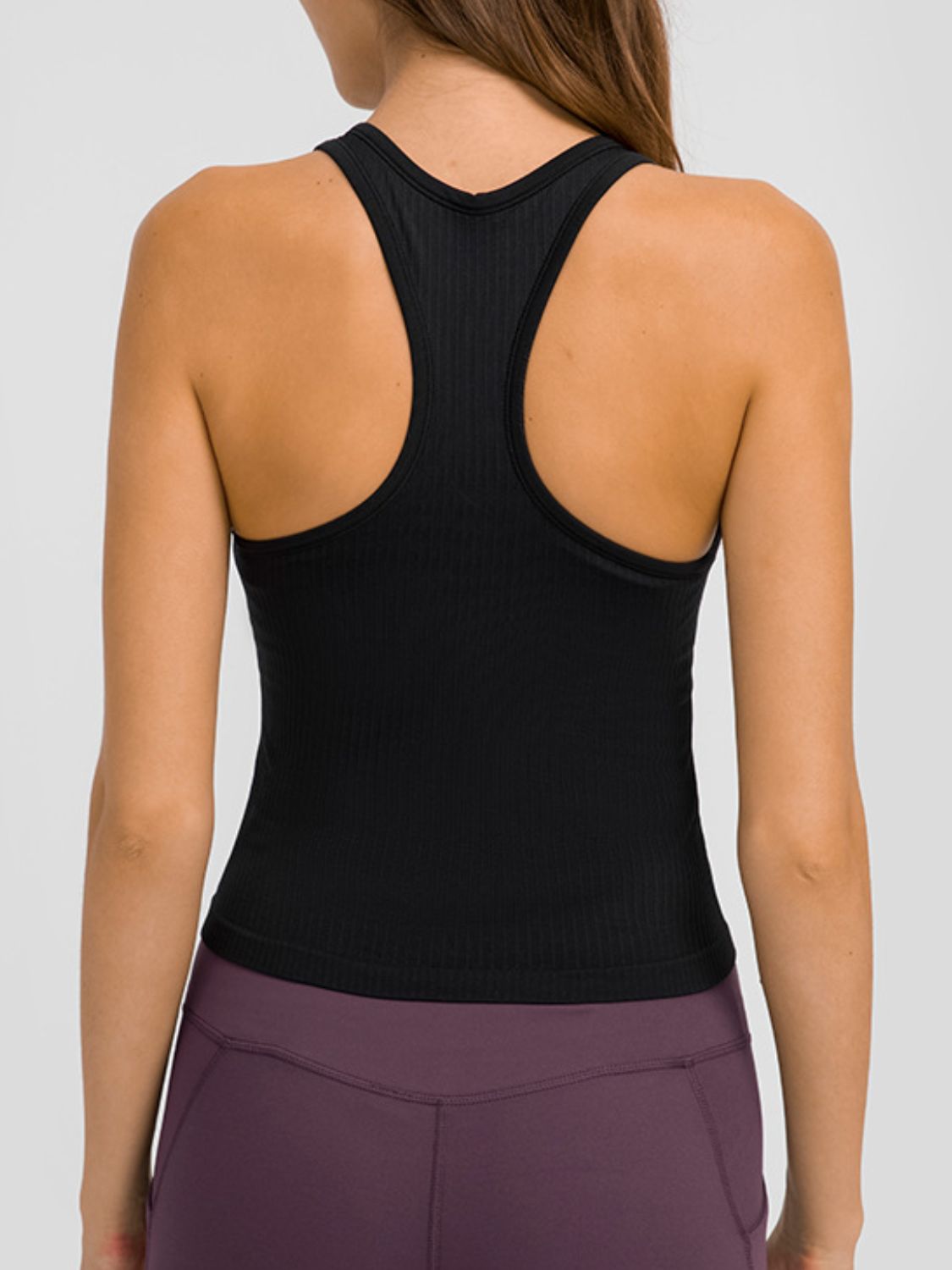 Round neck racerback active tank with removable padding.