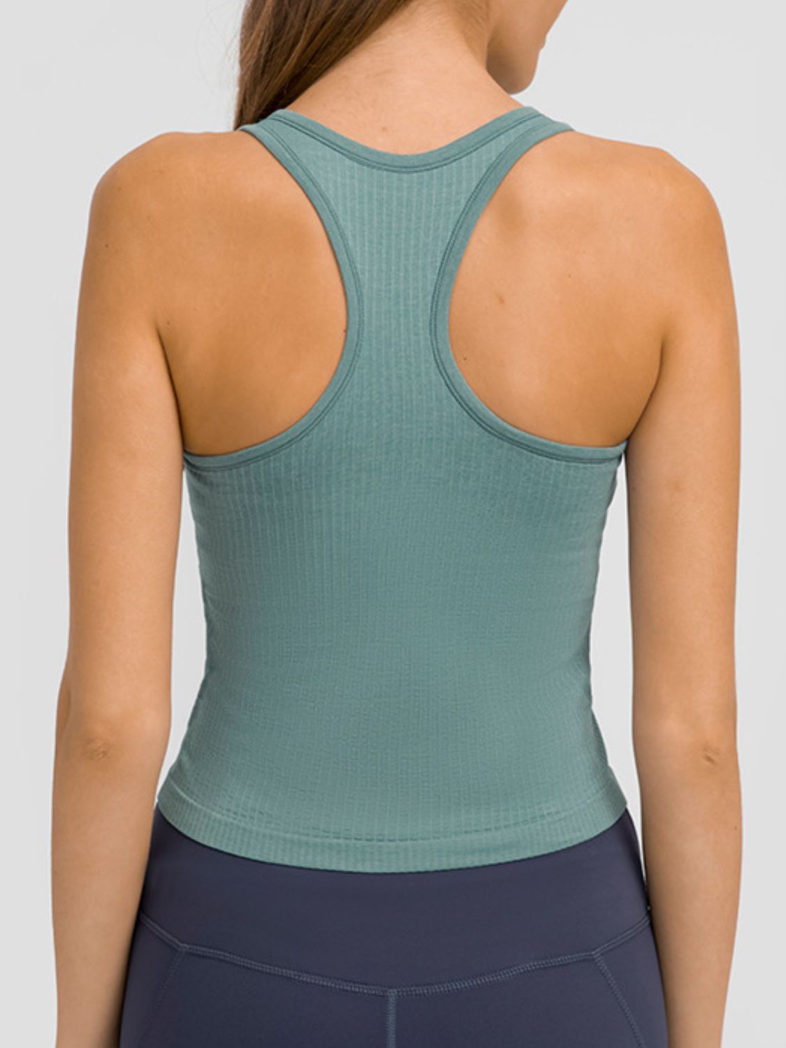 Round neck racerback active tank with removable padding.